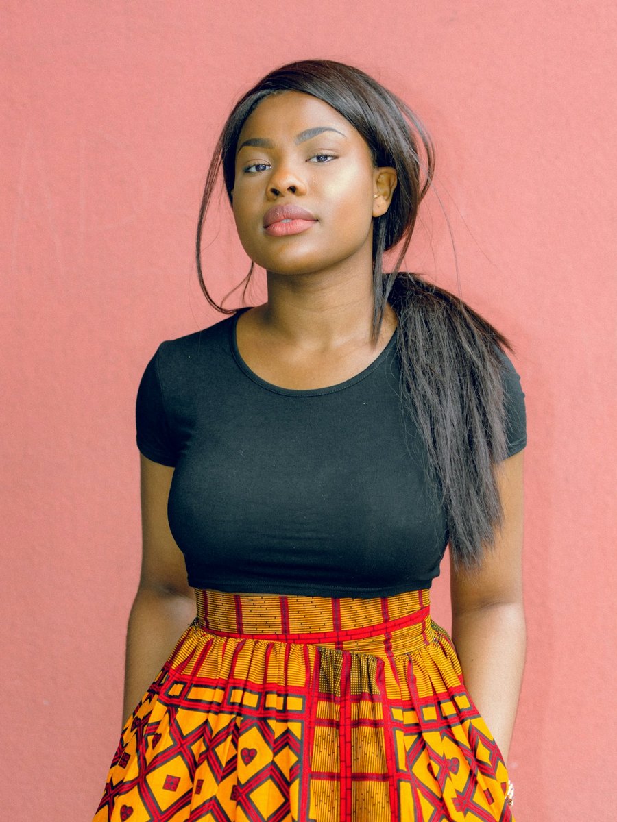 A woman looking toward the camera with quiet confidence.