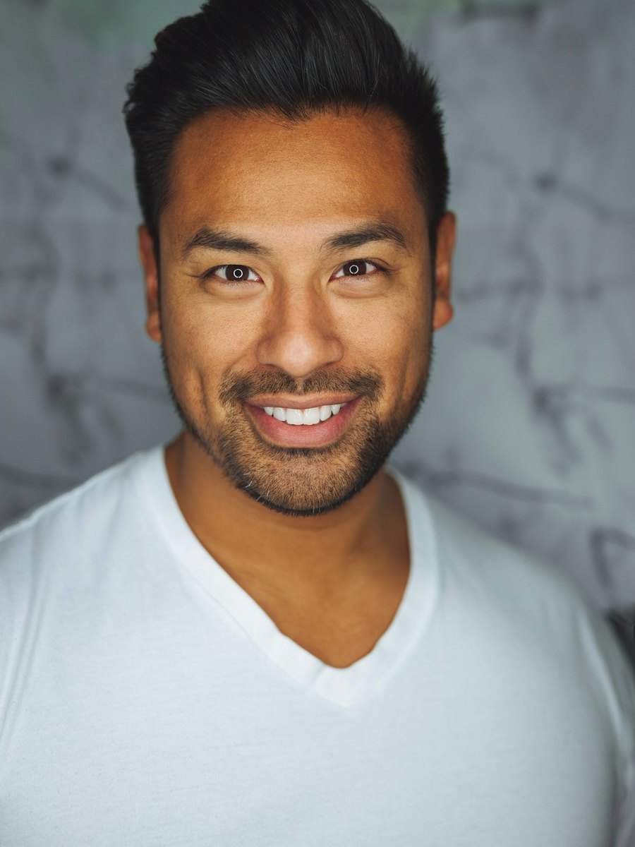 A man smiling toward the camera.
