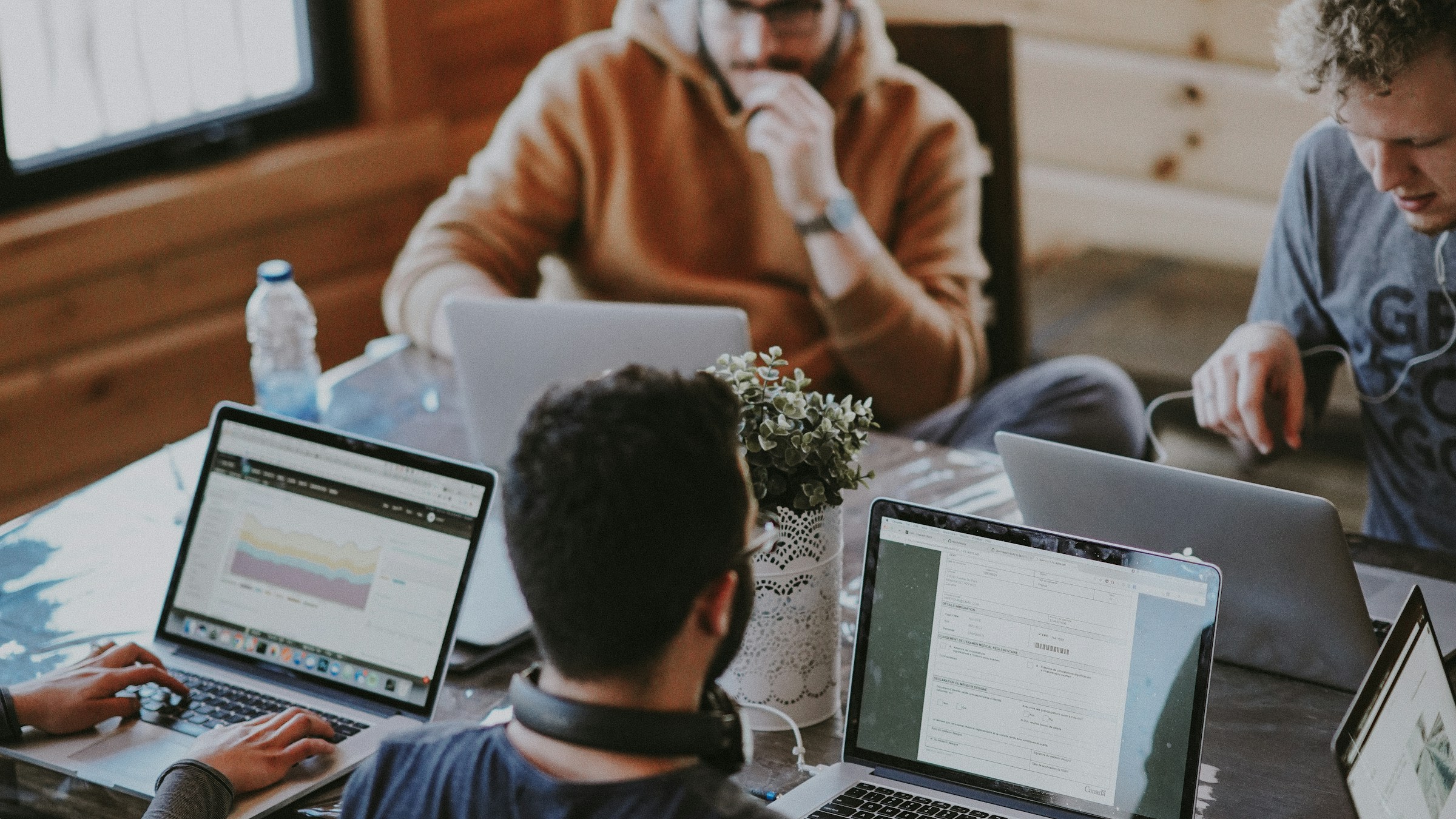 People working together around a shared table in warm afternoon light.